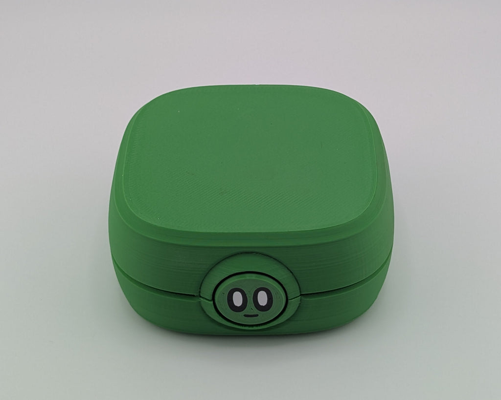 Green square-shaped container with a circular base on a light gray background
