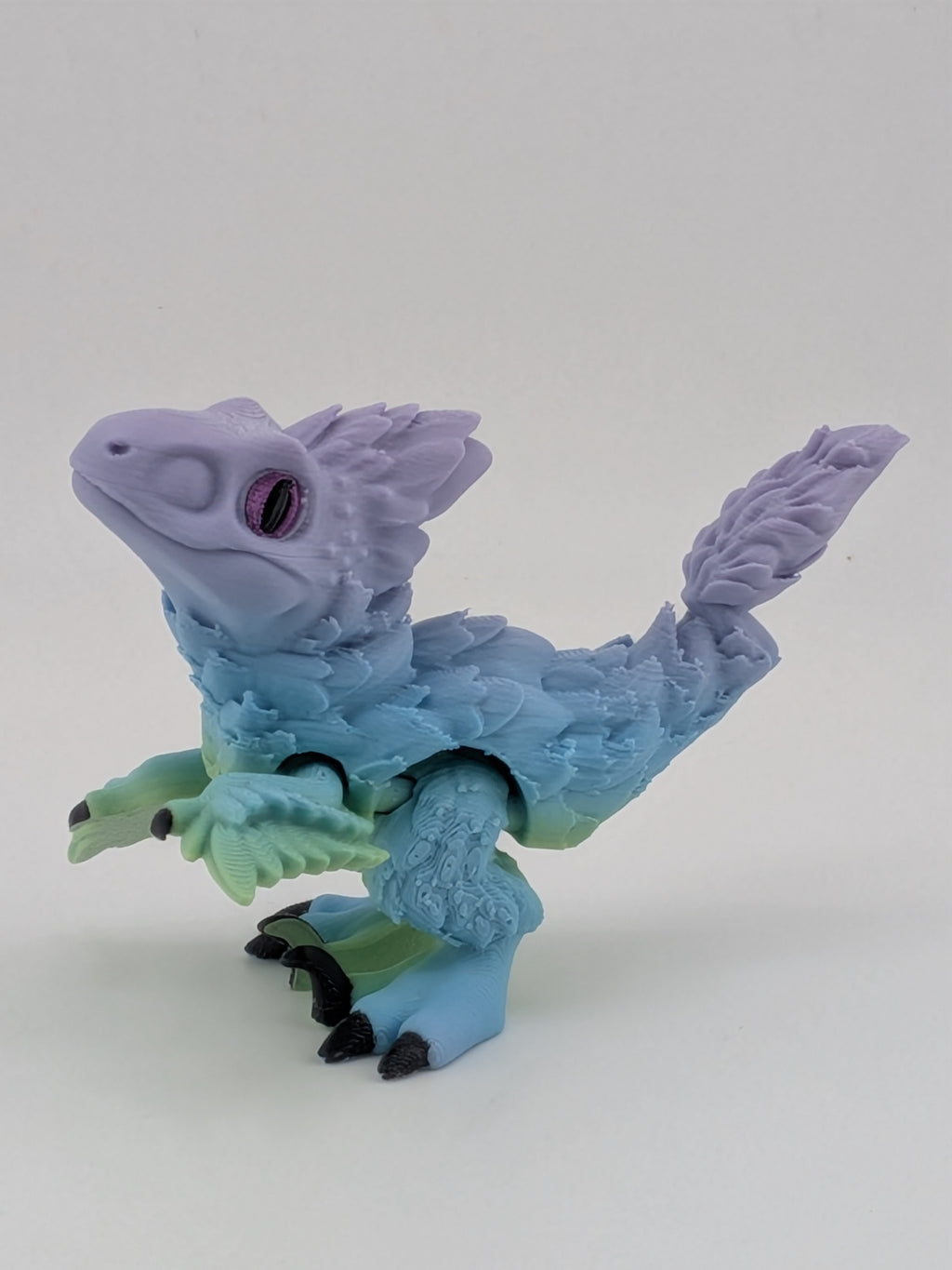 3.5 Inch Articulated Pyroraptor Dinosaur Camo and Pastel Rainbow Filament Toy