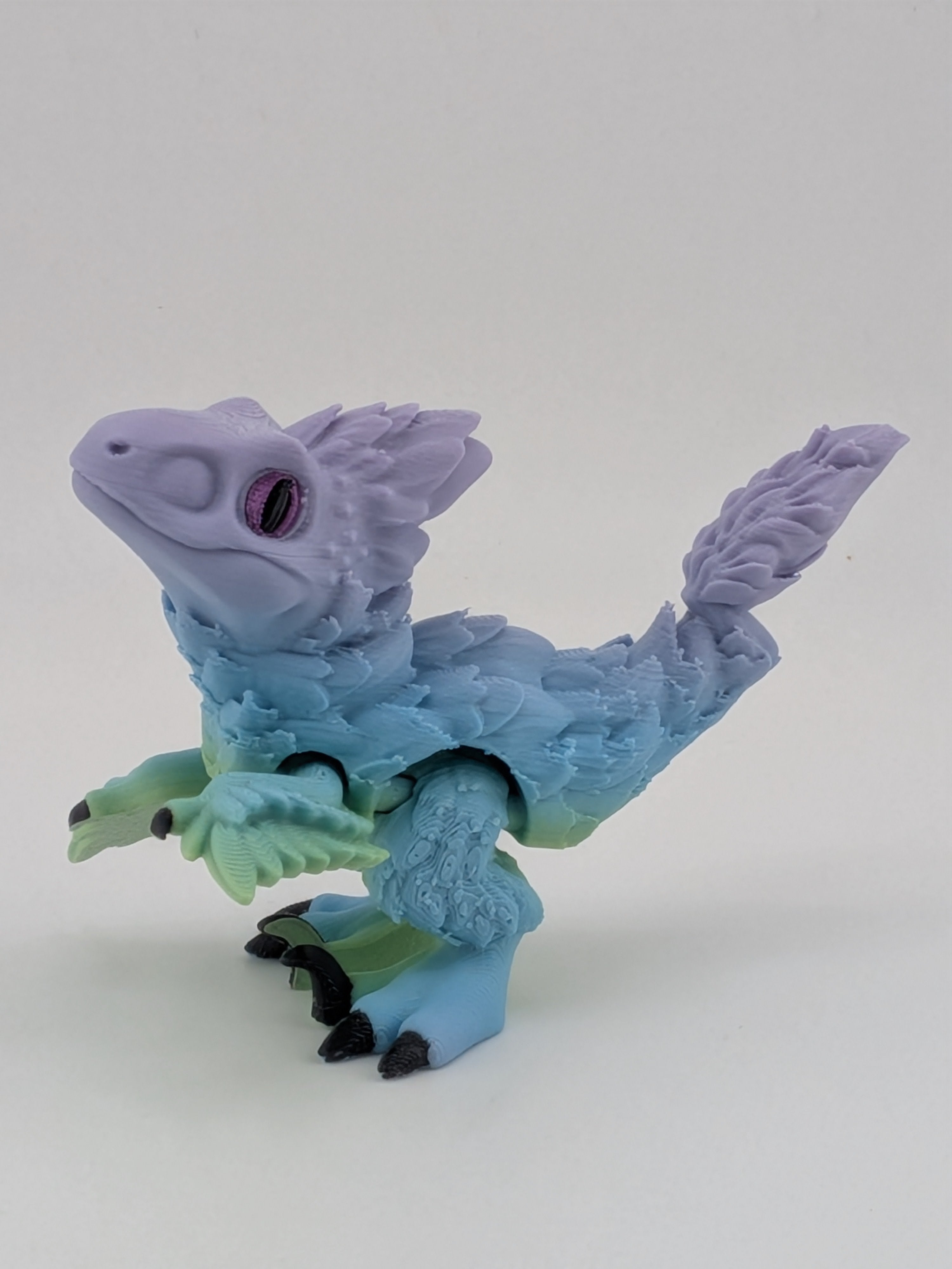 3.5 Inch Articulated Pyroraptor Dinosaur Camo and Pastel Rainbow Filament Toy