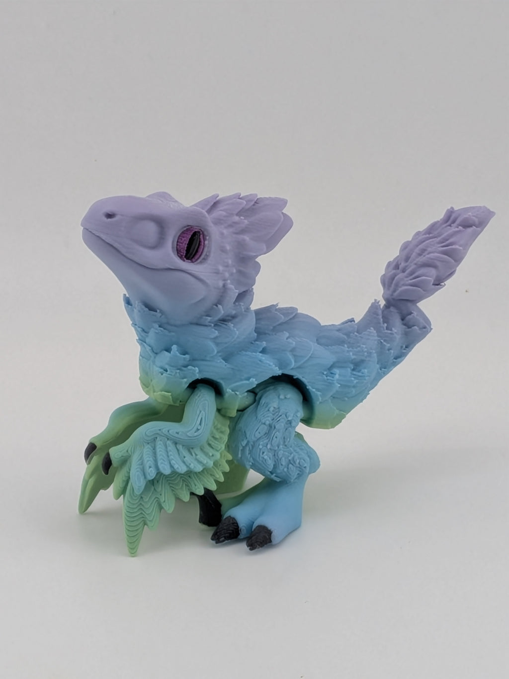 3.5 Inch Articulated Pyroraptor Dinosaur Camo and Pastel Rainbow Filament Toy